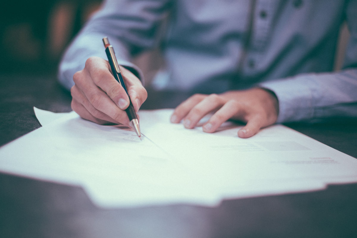 Man signing contracts